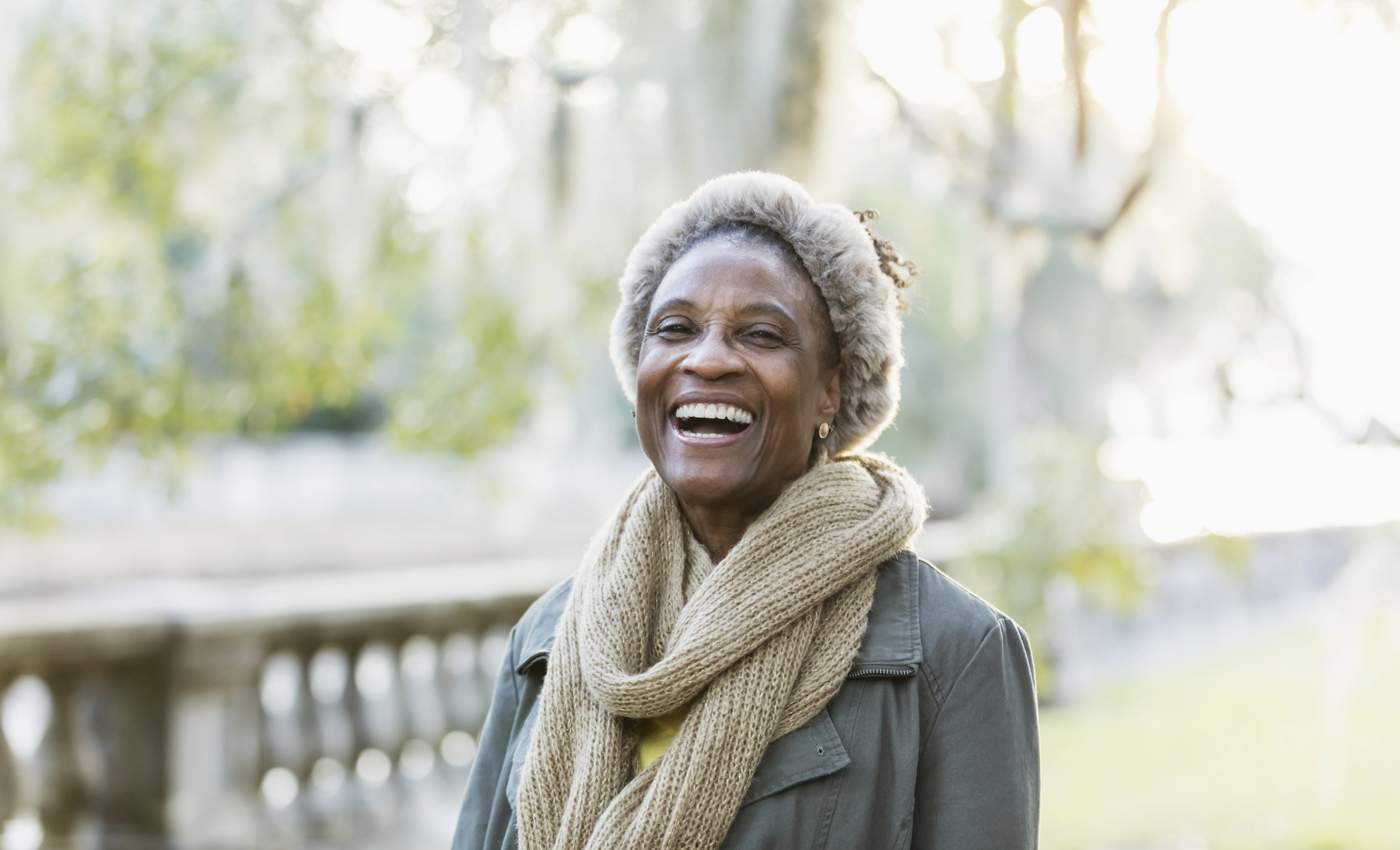 A laughing elderly woman in a park