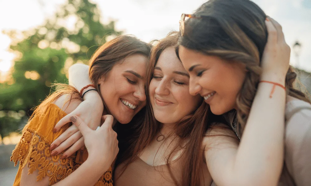 A woman group hugging her friends