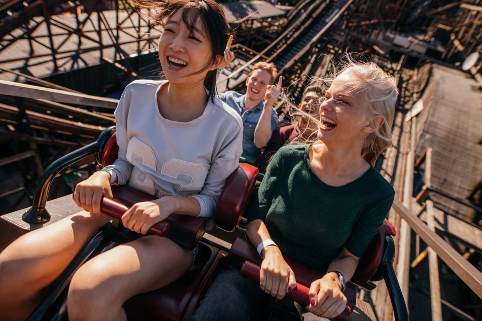 Two happy women on a rollercoaster