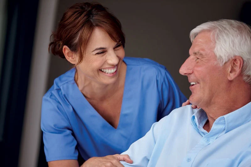 Smiling nurse with her elderly patient
